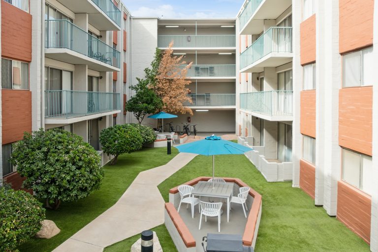 courtyard with patio tables at campus crossings on 8th street