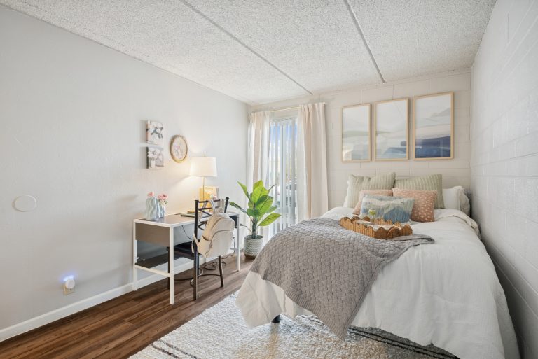 model bedroom with vinyl plank flooring at campus crossings on 8th street
