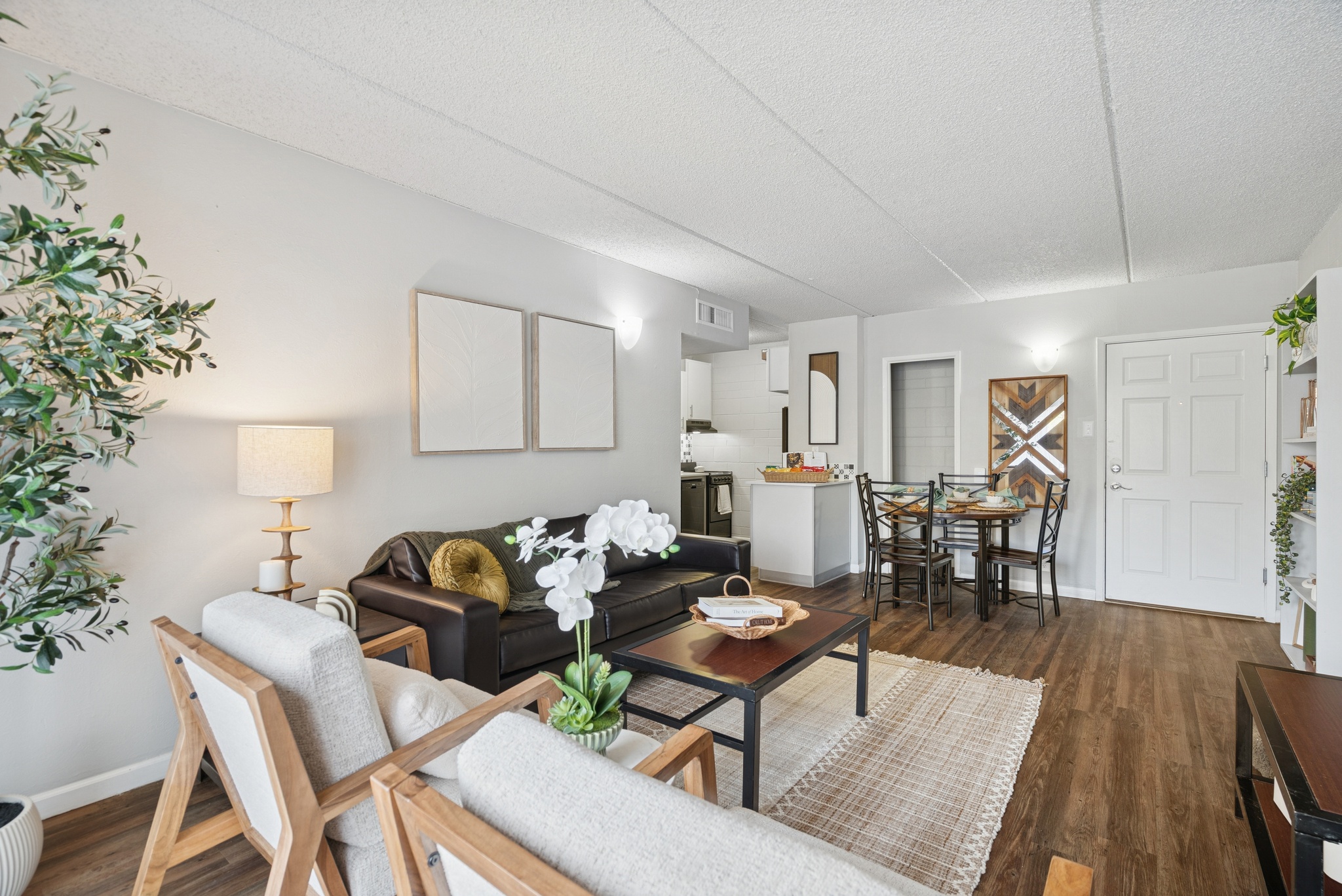 spacious living and dining area of a model apartment at campus crossings on 8th street