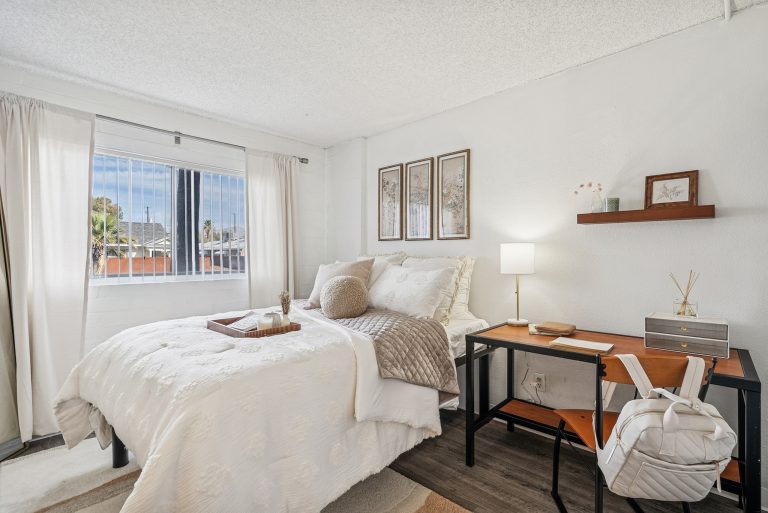 spacious model bedroom with desk and lots of natural light